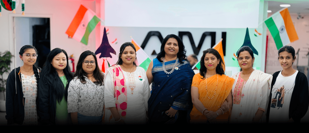 AM InfoWeb Republic Day event showing team members celebrating in traditional outfits with Indian flags at the office.