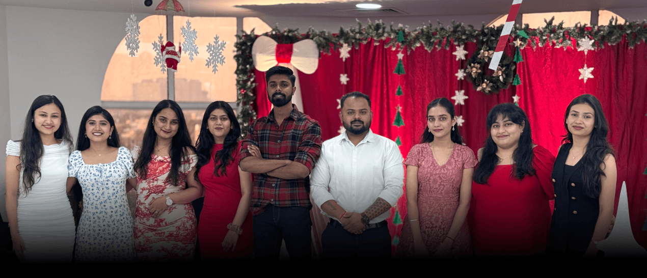 AM InfoWeb Christmas celebration showing employees dressed for a festive workplace event with holiday decorations.