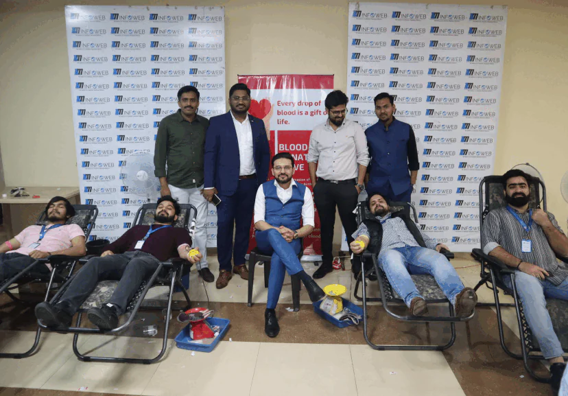 AM InfoWeb blood donation drive showing employees and volunteers donating blood during a community health initiative.