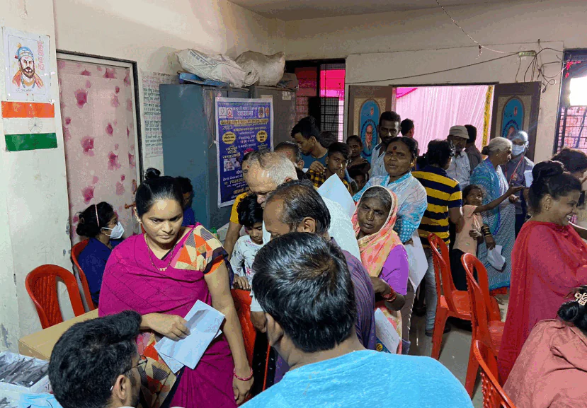 AM InfoWeb eye check-up camp showing community members receiving vision screening and healthcare support.
