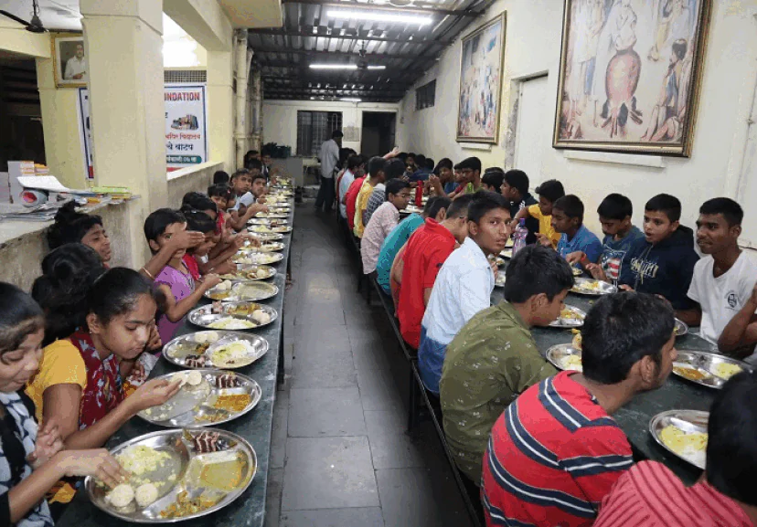AM InfoWeb food donation initiative showing children receiving meals as part of a community support and giving back program.