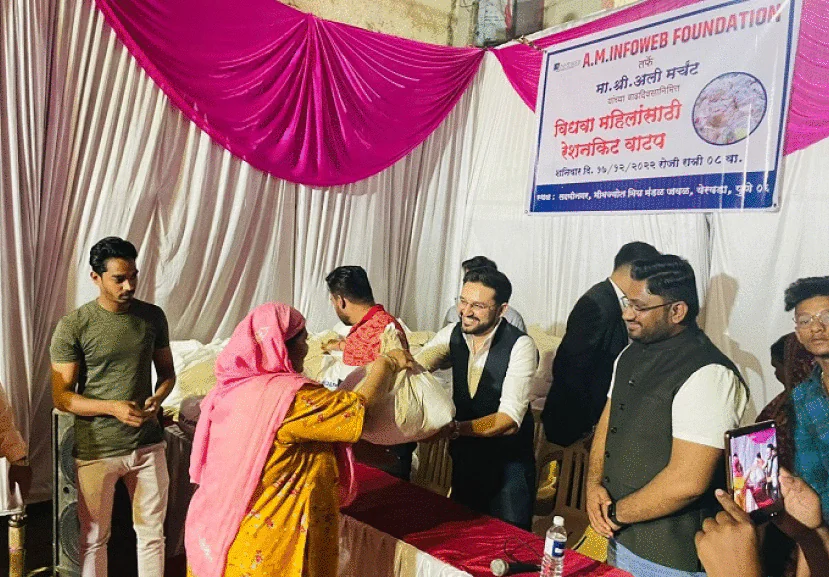 AM InfoWeb ration kit distribution initiative showing team members supporting community welfare through essential supplies.