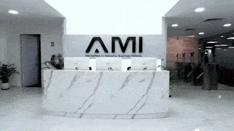 AM Infoweb reception area featuring the AMI logo wall, reflecting a professional workplace and trusted business operations environment.